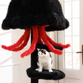 Cat sitting under a black unique cat towers design with red tentacles.
