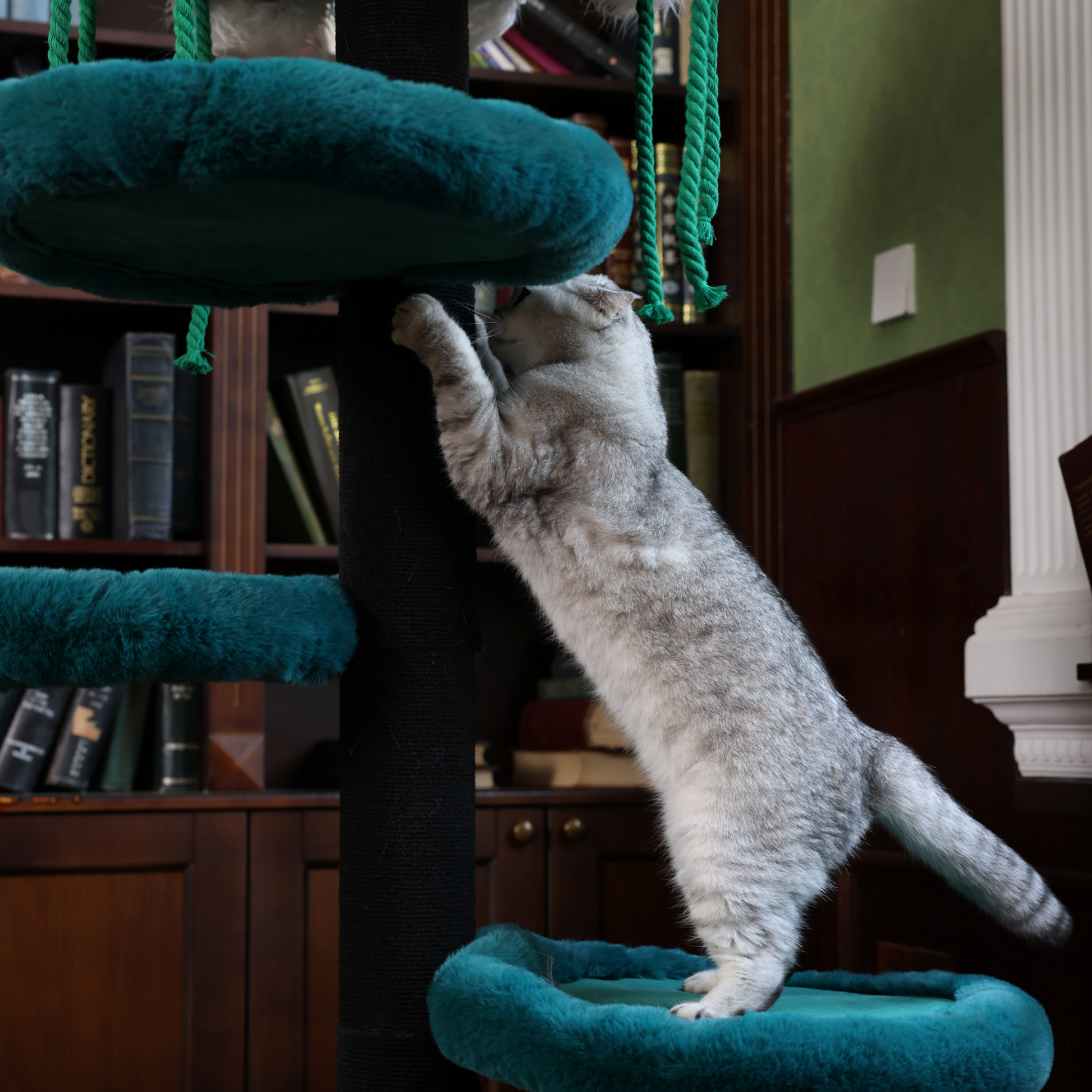 The tall cat scratching tower is made of solid wood and is extremely sturdy.